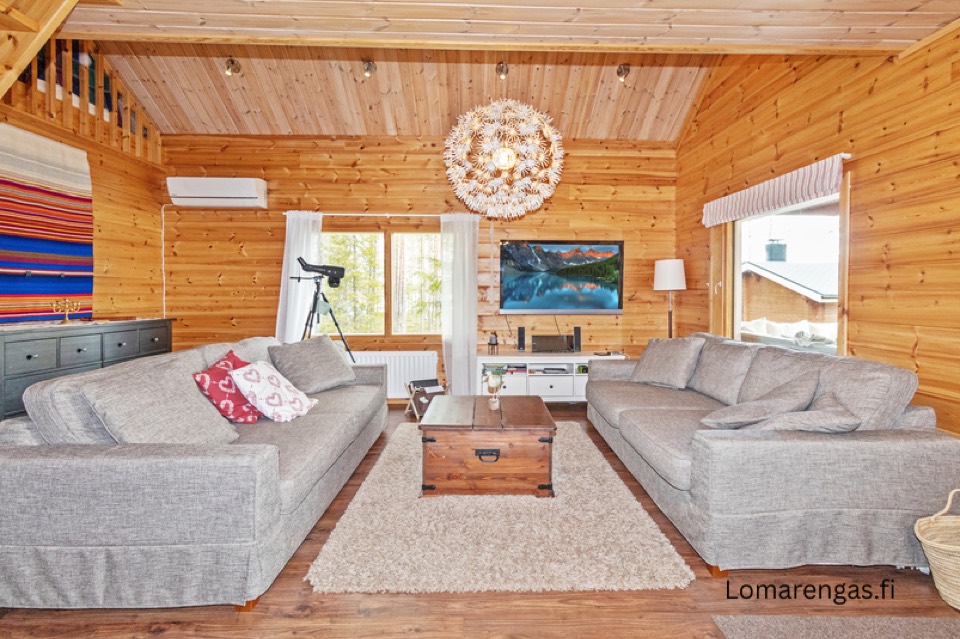 Wohnbereich im Haupthaus mit zwei Sofas und Holzwänden